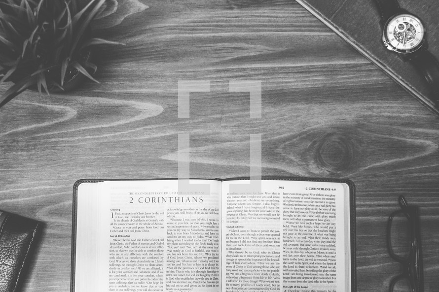 2 Corinthians, open Bible, Bible, pages, reading glasses, wood table 