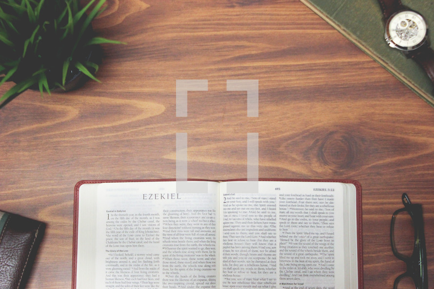 open Bible and reading glasses on a wood table - Ezekiel 