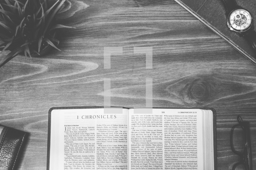 1 Chronicles, open Bible, Bible, pages, reading glasses, wood table 