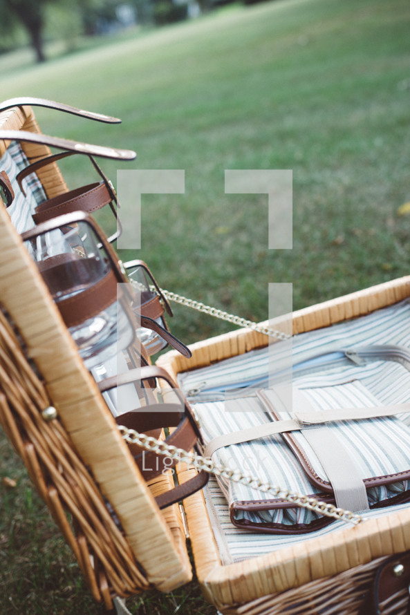 a picnic basket in the grass 