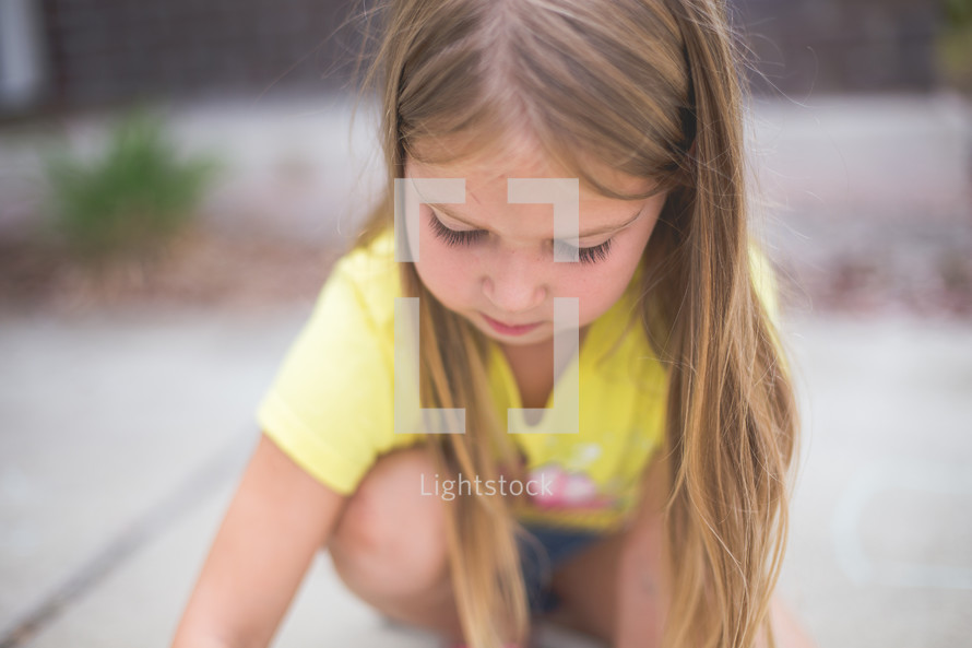 A young girl plays outside.