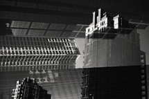 reflection in glass of skyscrapers in a city , double exposure photograph