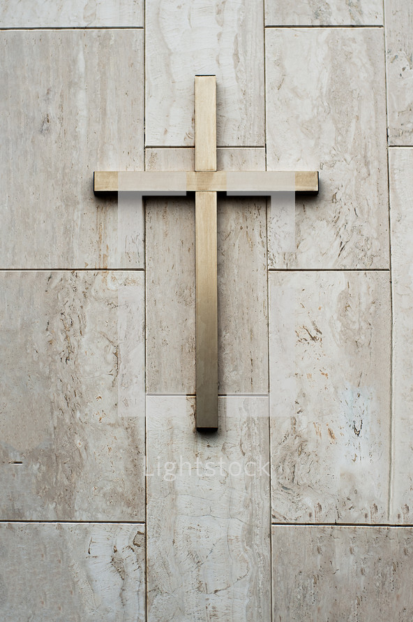 Cross on top of a marble wall