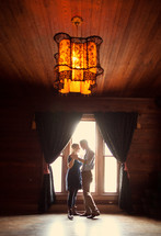 couple in front of a window dancing