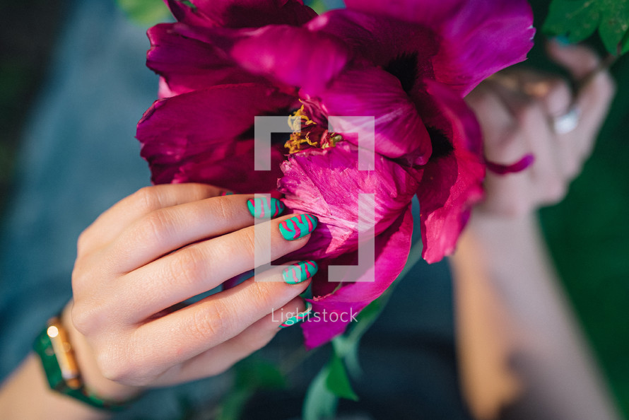 Creative vibrant pink nails art design, animalistic zebra pattern. Fuchsia color. Beautiful peony flower. High quality photo