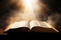 Open holy bible book on dark background with rays of light and smoke
