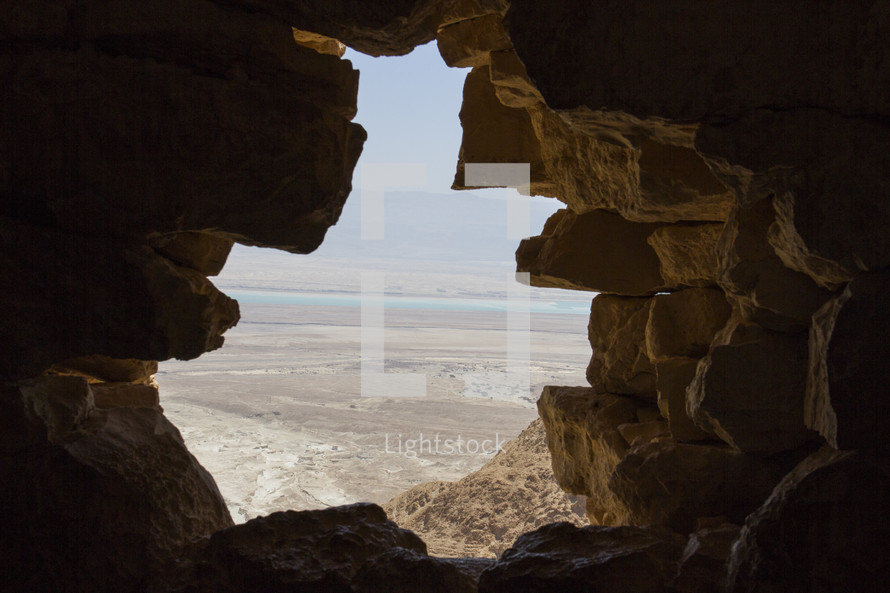 view of the holy land through the mouth of a cave 