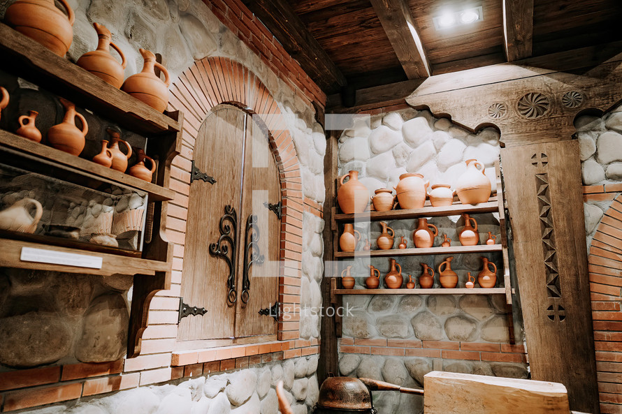 Traditional old wine cellar with handmade craft clay jugs. Antique winery concept. High quality photo