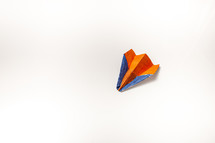 Color paper plane on a white background with copy space