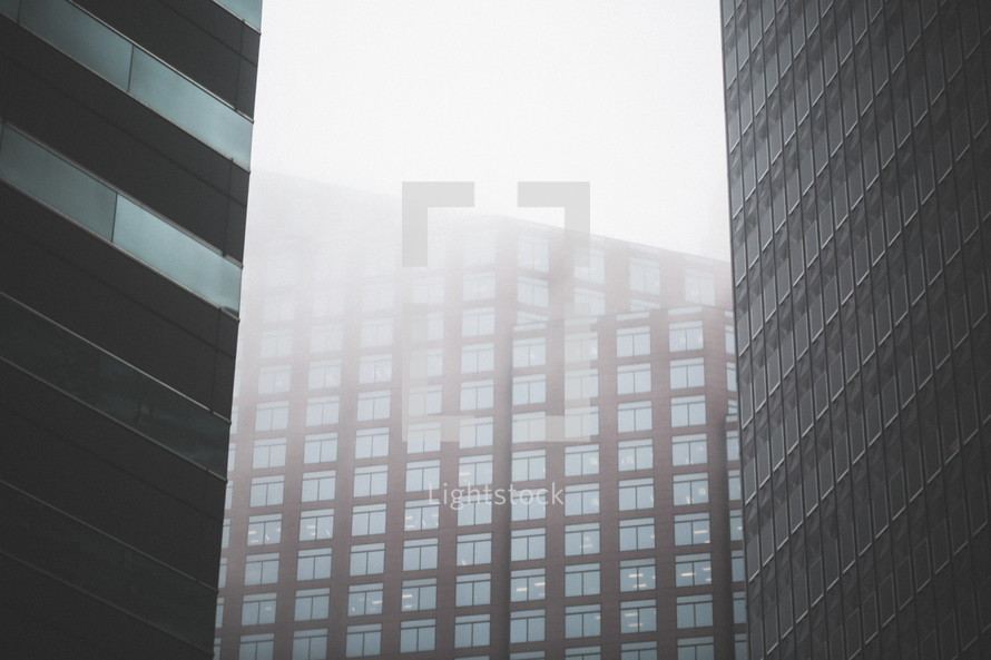 windows of a city building and fog