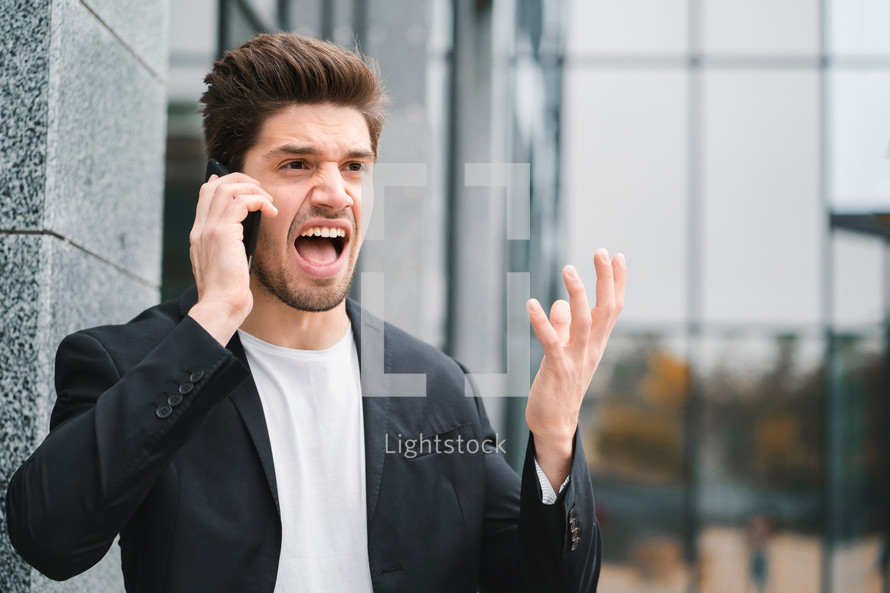 Businessman screaming on mobile phone. Having nervous breakdown at work, screaming in anger, stress management, mental distress problems, losing temper, reaction on failure.
