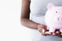 woman holding a piggy bank 