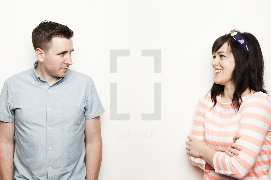 man looking annoyed at his wife's laughing.