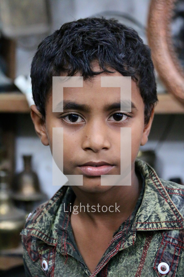 stoic face of a Bangladeshi boy