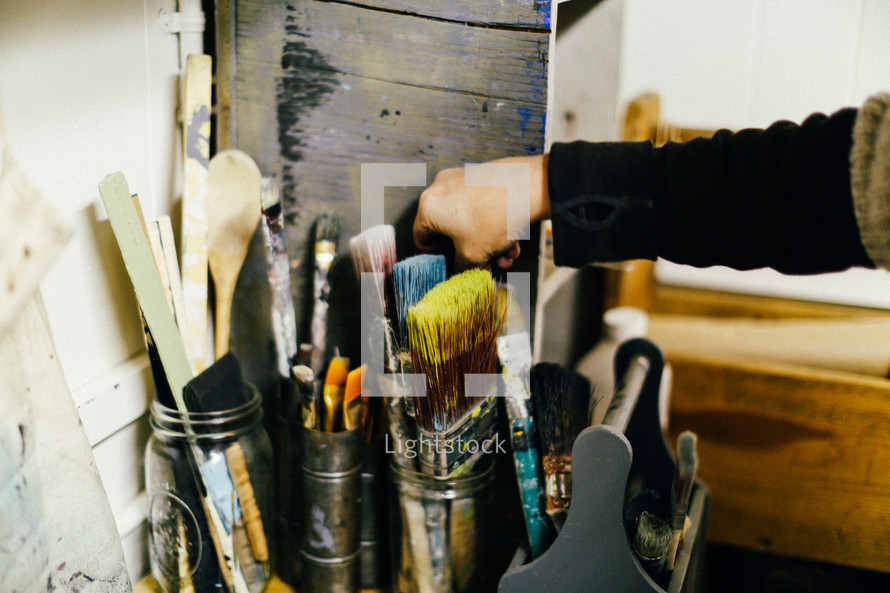 painting supplies and paint brushes in a tool box 