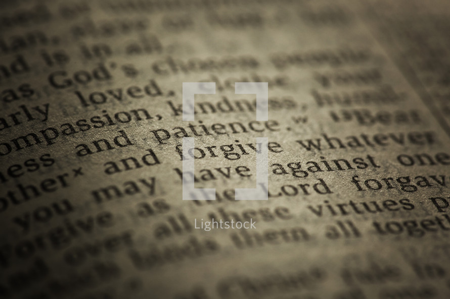 the word "forgive" on the page of a Bible.