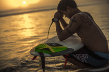 a surfer in meditation and prayer