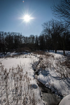 snow along the banks of a creek
