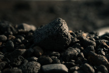 Black volcanic rock, porous stone on a beach
