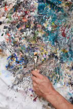 a man painting a canvas 