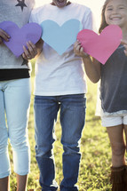 children holding paper hearts