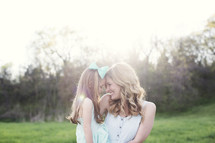  mother and daughter hugging outdoors 