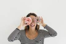a woman holding donuts