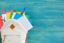 book bag with colorful school supplies 