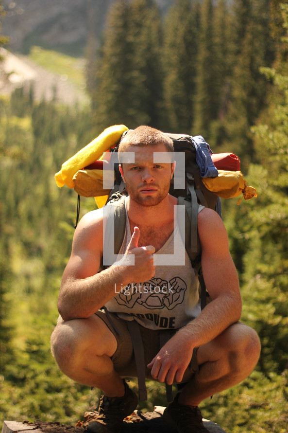 a man hiking with thumbs up 