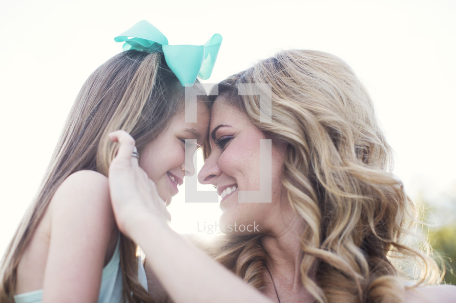 mother and daughter hugging outdoors 