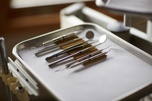 dental tools on a silver tray
