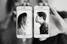 couple kissing on cellphones 