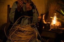weaving a basket in candlelight 