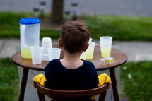 child with a lemonade stand 