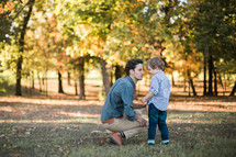 a father and son talking outdoors 
