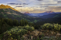 A beautiful sunset on the mountainside overlooking Mt Crested Butte on a wildflower summer day