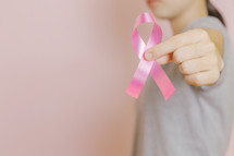 holding a pink ribbon 