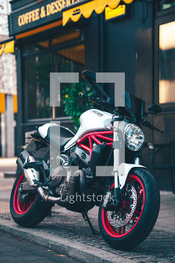 Ducati Monster 821 Italian motorcycle naked streetfighter white and red motorbike fast sports bike in an urban city setting