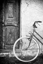 Old doors and wall with vintage bike, black and white shot