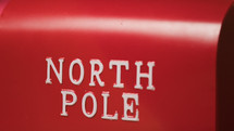 North Pole Sign on red Background