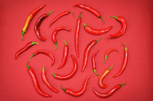 Red peppers on red background