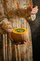 a woman making squash soup 
