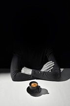 Anonymous person with arms crossed and a cup of coffee