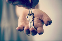 a man handing a woman keys.