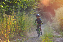 child riding a bike on a trail 