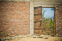 Rustic doorway in a brick wall.