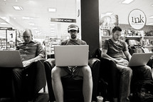 men on their laptops at a bookstore