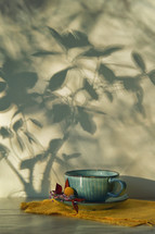 Abstract Autumn shadow branches and cup of tea