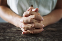 close up of woman with folded praying hands 