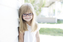 face of a girl child wearing glasses 